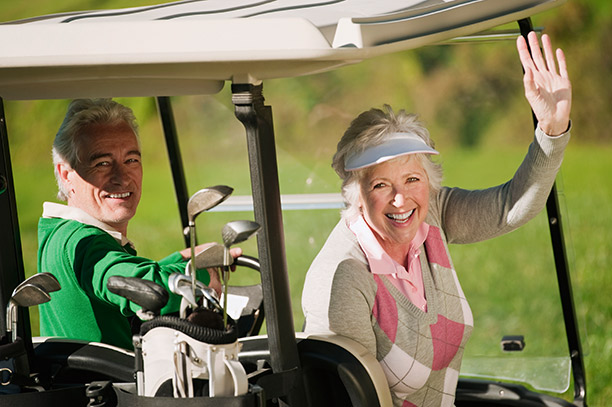 Photo of couple on vacation golfing