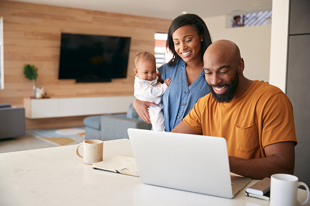 Photo of young family researching life insurance options